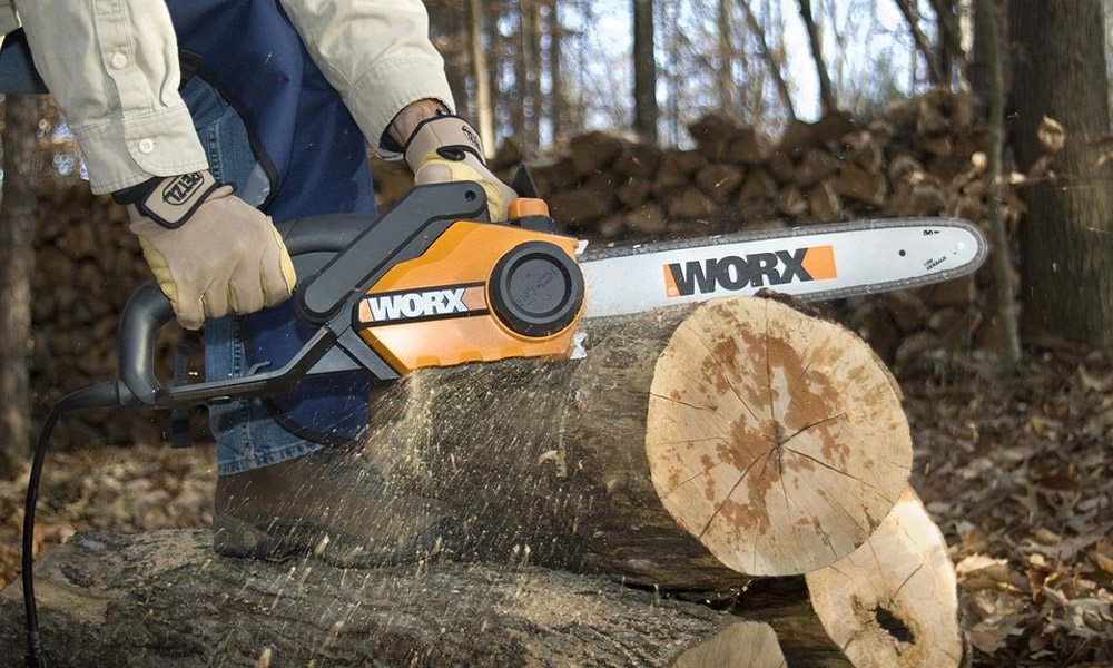 Worx electric chainsaw cutting through a log