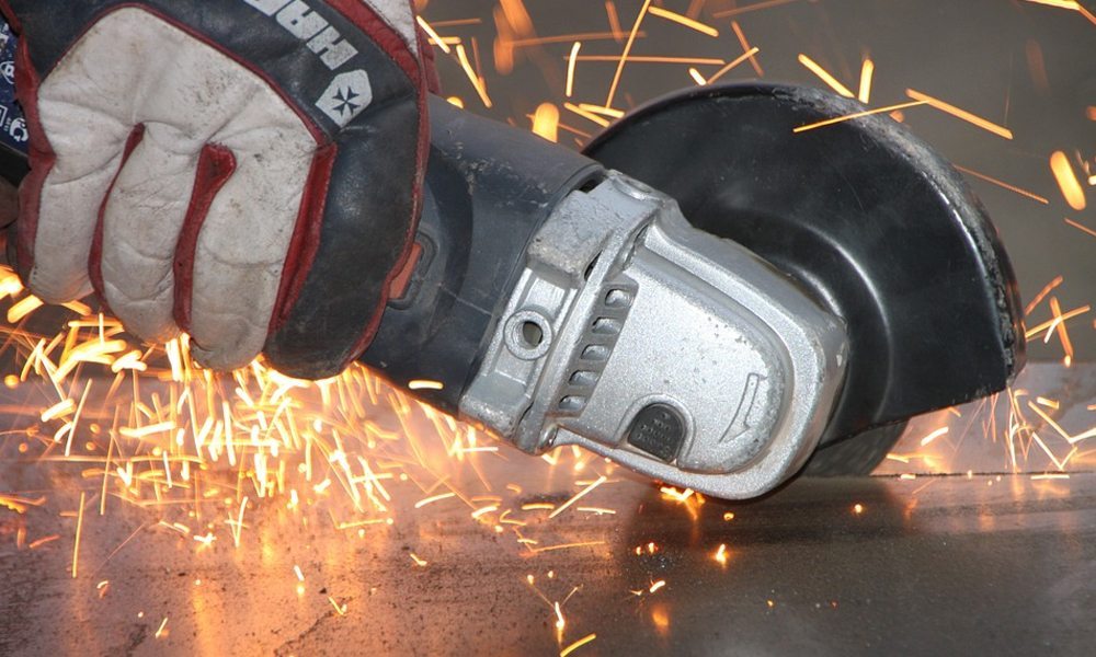  angle grinder cutting with sparks coming off the metal