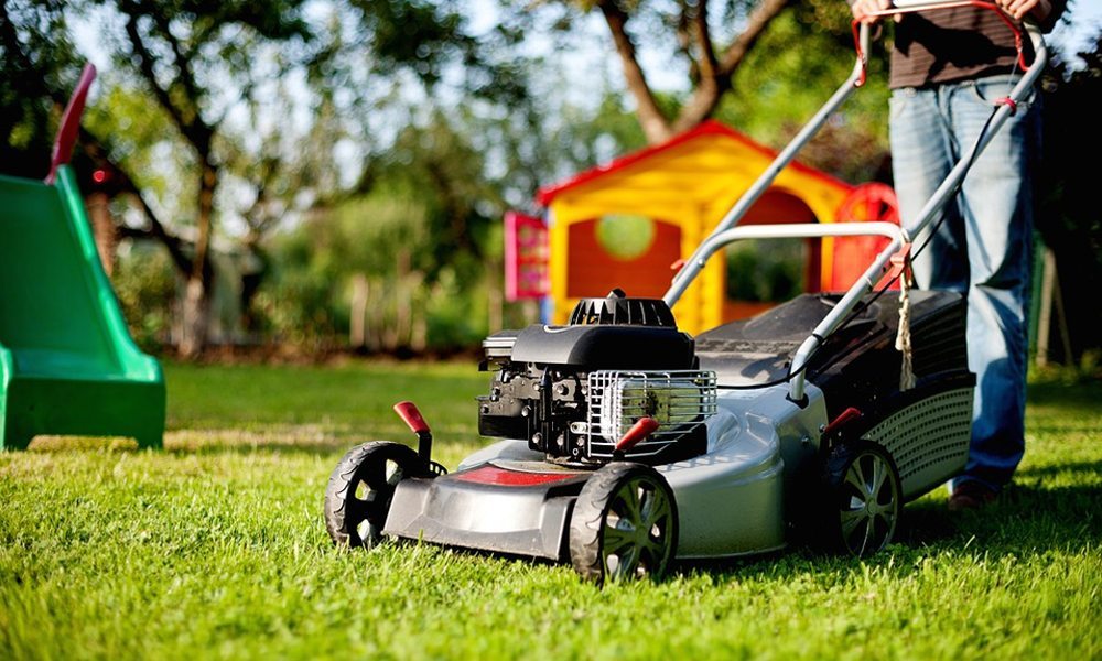 Silver and Red Lawn mower on grass