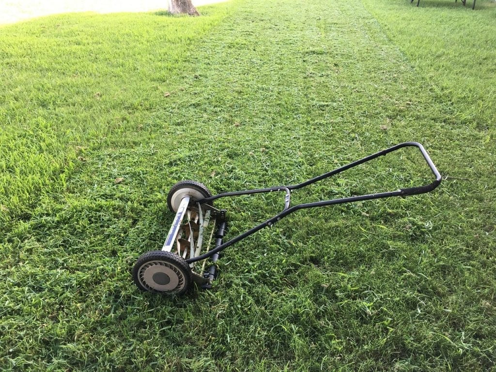 reel mower laying down on lawn