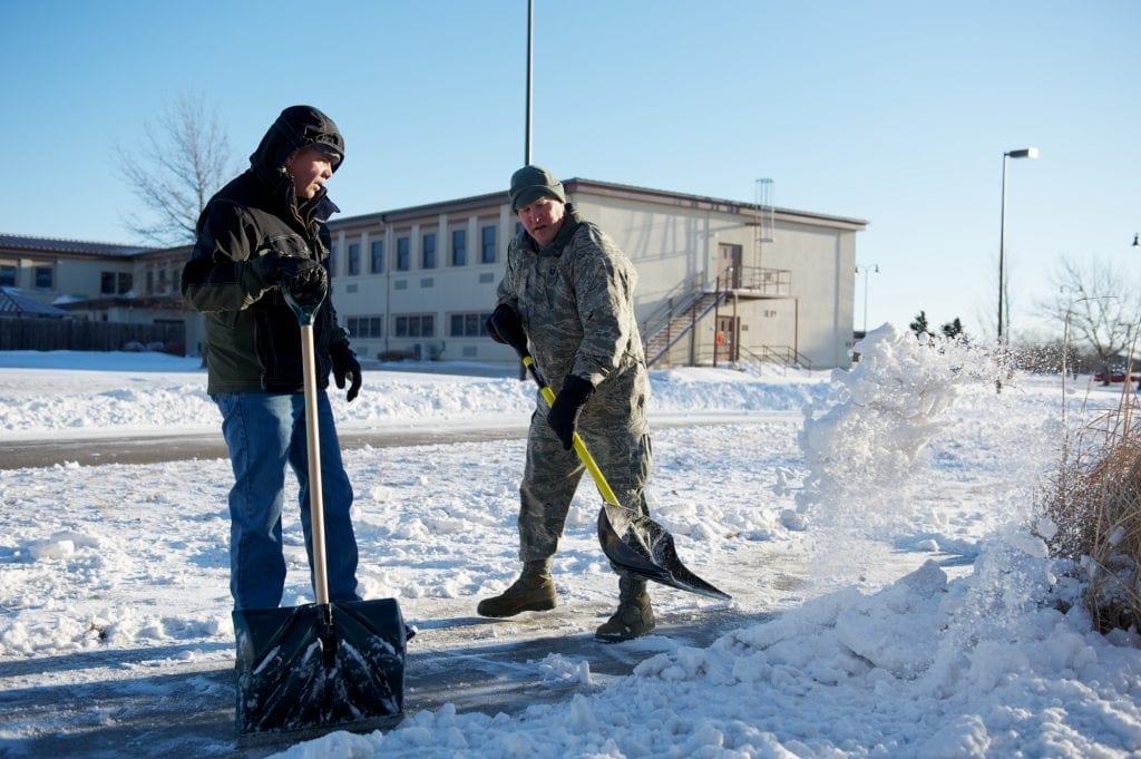 Two men using snow shovels