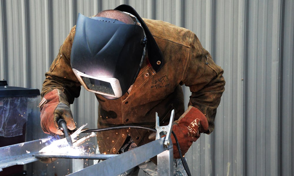 A person wearing protective clothing while welding