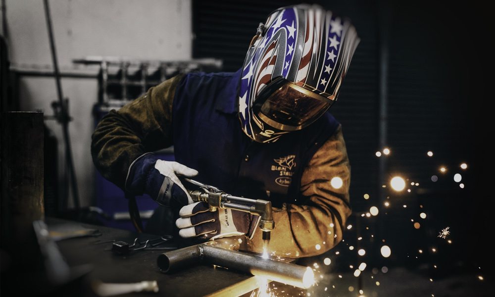 someone wearing a welding helmet while welding