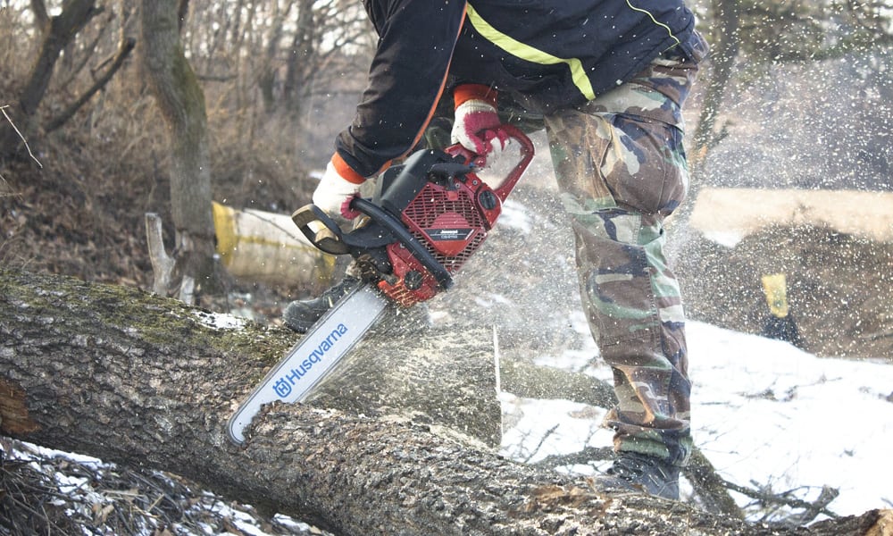 A workman using a chainsaw 