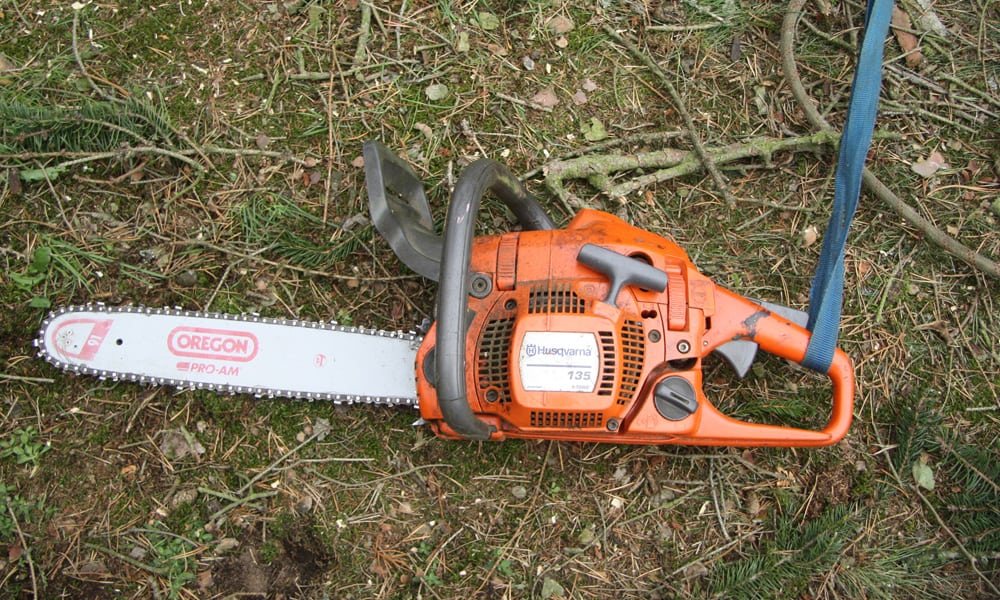 A chainsaw laying on the ground