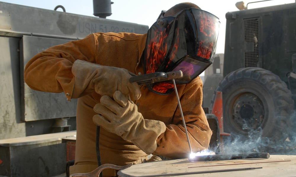 a work person wearing a welding helmet