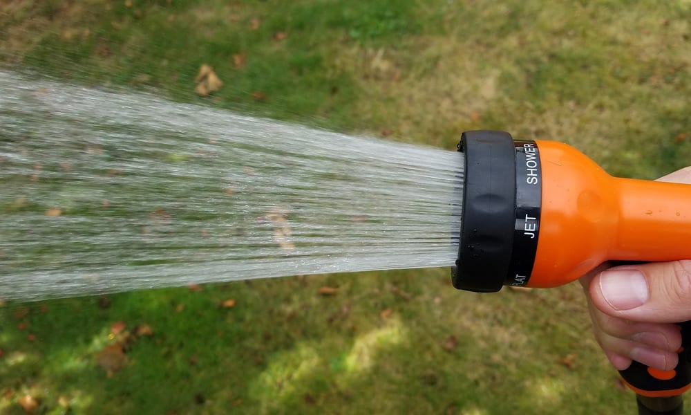 hose nozzle spraying water out of it.