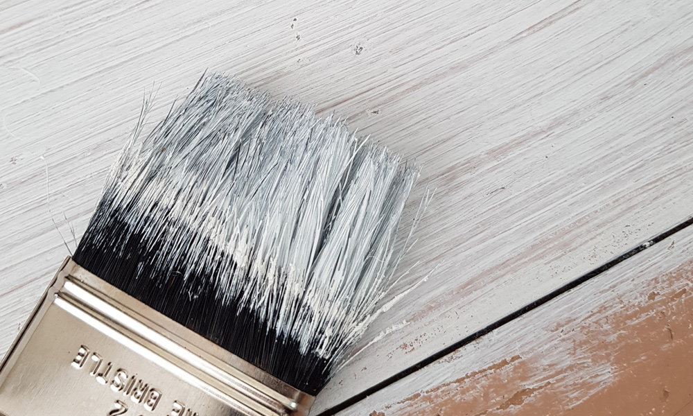 paint brush with chalk paint on it.