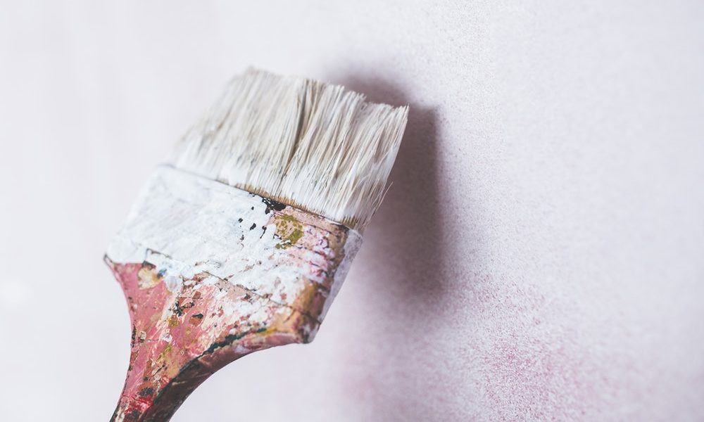 paint brush painting a white wall