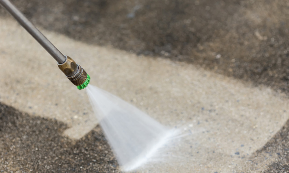 pressure nozzle spraying on concrete