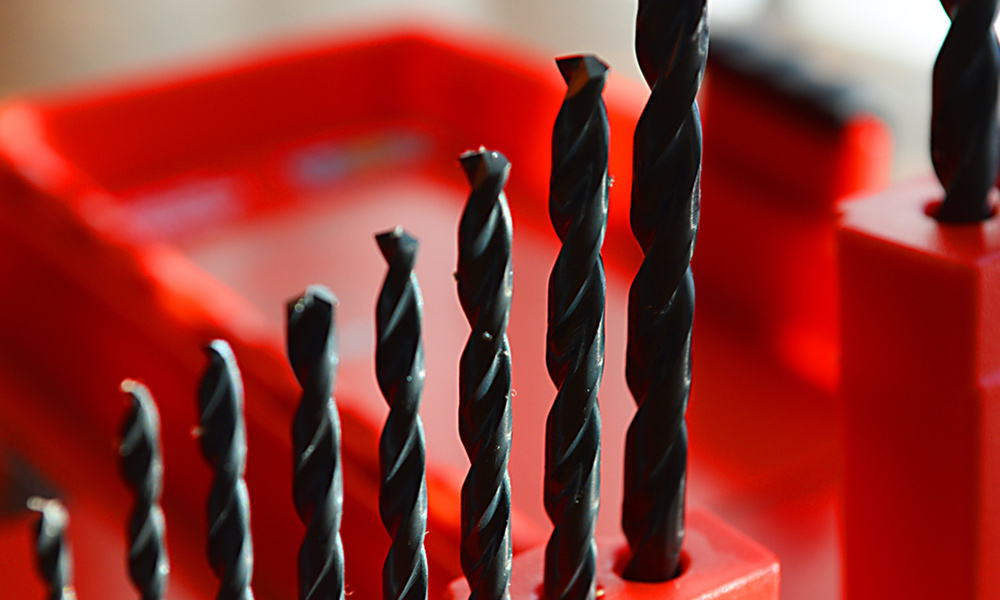 Different size drill bits in a row
